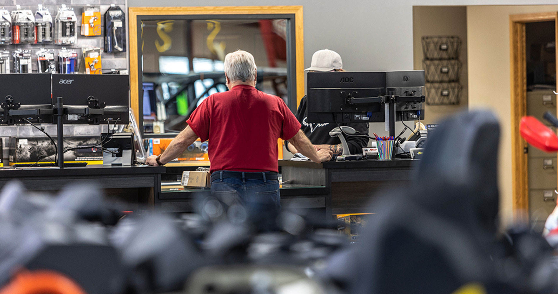 A man standing at a counter of a hardware store